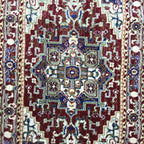 Maroon and green Persian runner rug detail